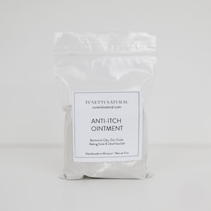 May include: A white plastic bag with a label that reads "TUNETTI NATURAL tunettinatural.com ANTI-ITCH OINTMENT Bentonite Clay, Zinc Oxide Baking Soda & Dead Sea Salt Handmade in Missouri Net wt 3 oz"