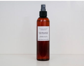 May include: A brown glass bottle with a spray nozzle, containing a clear liquid. The label reads "TUNETT NATURAL" and "ALOE VERA LEAVE-IN HAIR CONDITIONER".
