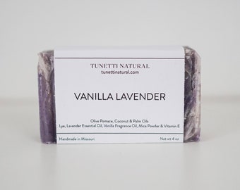 May include: A rectangular bar of handmade soap with a white label that reads "VANILLA LAVENDER." The soap is a marbled purple and white color. The label also lists ingredients and the net weight of 4 oz.