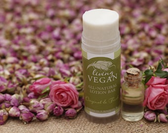 May include: A white all-natural lotion bar with a green and white label that reads "living VEGAN" and "Original & Fresh". A small glass bottle with a cork stopper and a clear liquid is next to the lotion bar. Pink roses and rose buds are in the background.