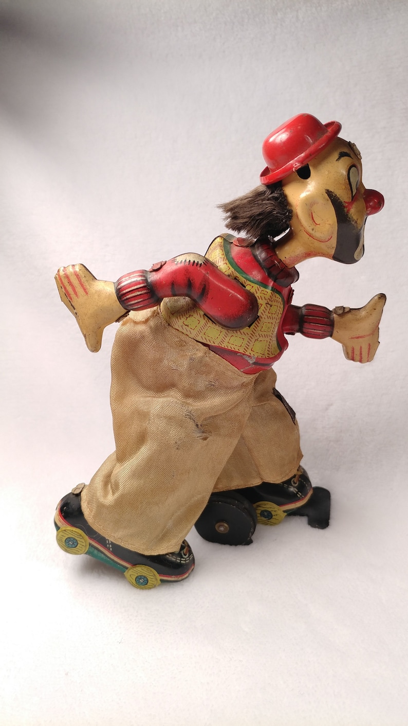 Vintage Tin toy windup Skating clown hobo