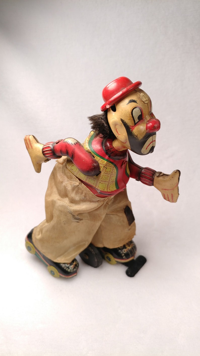 Vintage Tin toy windup Skating clown hobo