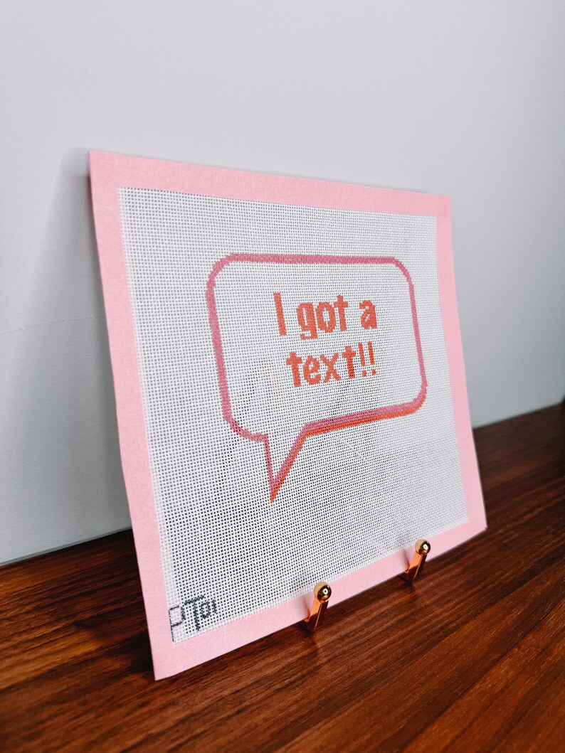 K&ouml;nnte beinhalten: Ein rosa Canvas mit rosa Rand, auf dem eine wei&szlig;e Sprechblase mit dem Text "Ich habe eine SMS!" in Orange zu sehen ist.