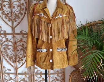 May include: A brown suede jacket with fringe detailing and Native American inspired beadwork. The jacket has a button closure and long sleeves.