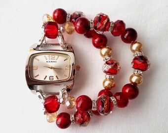 This is a classic red and gold woman's stretch beaded watch featuring red/gold/black rhondelle beads and red beads with a hint of black.