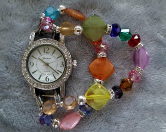 Women’s unique interchangeable stretch watch with multicolored beads and a round white watch face.