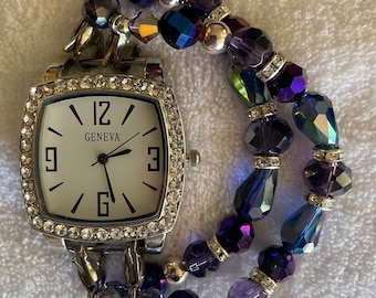 Women’s lovely iridescent interchangeable beaded bracelet watch with square silver watch face surrounded with rhinestones.