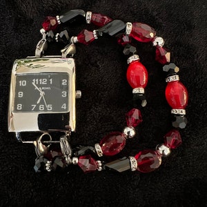 This is a striking red/black stretch interchangeable watch band connected to a black and silver watch face.