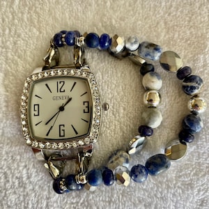 Women&#39;s unique denim-inspired beaded interchangeable watch band. Features blue-gray and silver beads.
