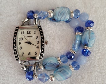 This delicate blue ladies interchangeable stretch beaded watch has light blue rectangular beads with a pearl watch face.