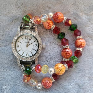 Women&#39;s vibrant autumn colored stretch watch bracelet with round watch face.