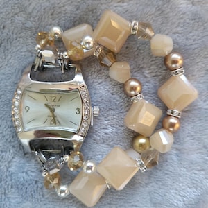 Women&#39;s lovely tan and gold interchangeable stretch watch bracelet with a rectangular watch face.