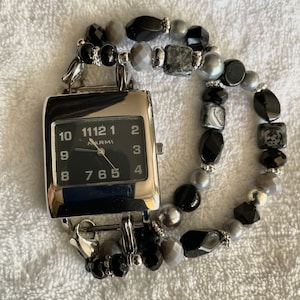 This bold black and gray stretch interchangeable bracelet is featured with a black and silver square face.