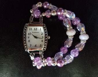 Woman's lovely lilac stretch beaded watch bracelet with oval watch face.