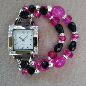 Women’s lively fuchsia and black stretch watch bracelet with a white square watch face.