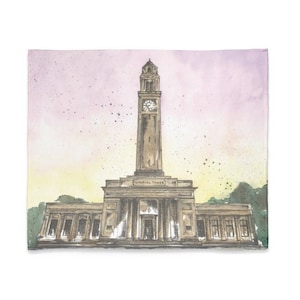 May include: A watercolor painting of a building with a clock tower. The building is a light brown color and has a white trim. The clock tower is tall and has a pointed roof. The sky is a light pink color with white clouds. The text "Memorial Tower" is visible on the building.