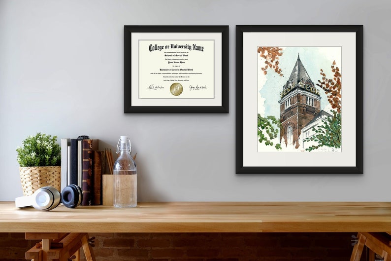 May include: Two framed prints on a wall. The print on the left is a diploma with a gold seal. The print on the right is a watercolor painting of a brick building with a tower. The building has the words "Fenn College" on the tower.