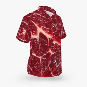 May include: A red and white short-sleeved button-down shirt with a pattern that resembles a raw steak.