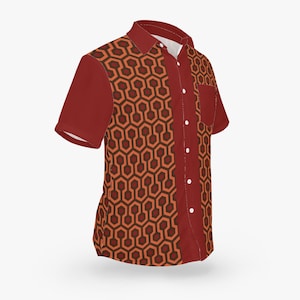 May include: A red short-sleeved button-down shirt with a geometric pattern in orange and brown. The pattern is reminiscent of a hotel carpet.