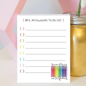 May include: A white to-do list with the text "(Mrs. Arrowood's To Do List)" at the top. The list has eight lines with curly brackets to the left of each line. The bottom of the list has a rainbow of colored markers with the text "teaching with flair" below the markers.