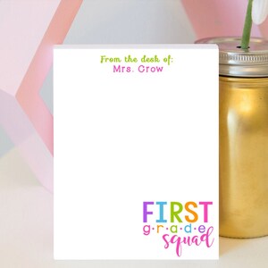 May include: White notepad with the text "From the desk of: Mrs. Crow" at the top and "FIRST grade squad" at the bottom. The text is in a colourful font.