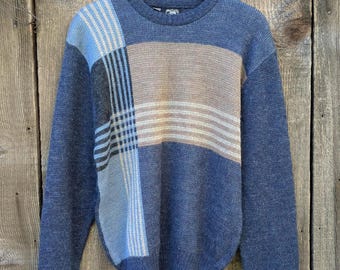 May include: A blue, brown, and white plaid sweater with long sleeves.