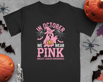 May include: Black t-shirt with a pink ghost holding a pumpkin and the text "In October We Wear Pink" with the words "Breast Cancer Awareness" below.