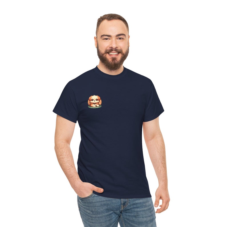 May include: Navy blue t-shirt featuring a small embroidered illustration of a light brown and white puppy sitting down. The puppy is centered on the left chest area of the shirt. The shirt is a classic crew neck style and appears to be made of a soft, comfortable fabric.