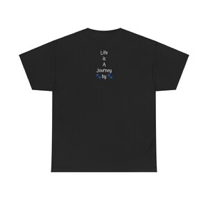 May include: Black short sleeve t-shirt with a vertical text graphic on the back. The text reads: 'Life is A Journey by' with small paw prints underneath. The shirt is a classic fit and is made of 100% cotton.