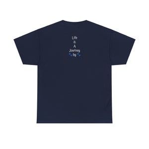 May include: Navy blue t-shirt featuring a vertically stacked text design on the back. The text reads 'Life is A Journey by', with small paw prints between 'Journey' and 'by'. The shirt is a simple, casual style, suitable for everyday wear.