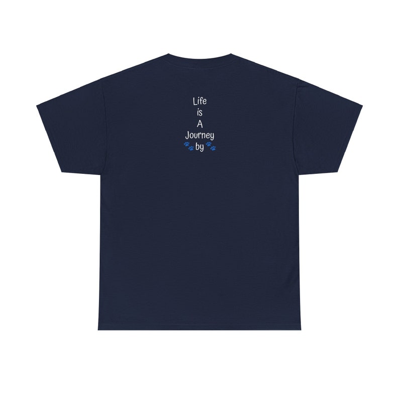 May include: Navy blue t-shirt featuring a vertically stacked text design on the back. The text reads 'Life is A Journey by', with small paw prints between 'Journey' and 'by'. The shirt is a simple, casual style, suitable for everyday wear.