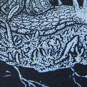 May include: A black fabric featuring a light blue screen-printed graphic of a snail with a textured shell. The design includes intricate line work depicting the snail moving across a patch of ground with small plants and roots visible below.