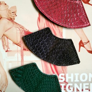 May include: Three leather fan-shaped bookmarks in green, black, and pink with a textured snakeskin pattern.