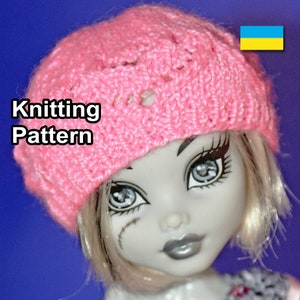 May include: Pink knitted hat with a lacy pattern, worn by a doll with white hair and grey makeup. The text "Knitting Pattern" is visible in the image.