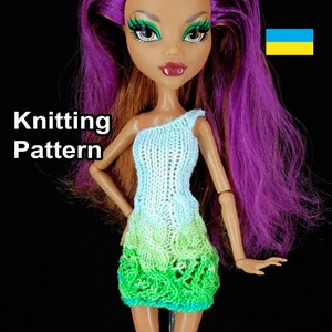 May include: Knitting pattern for a doll's dress. The dress is white with a green ombre skirt. The doll has purple hair and green eyes.