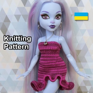 May include: Knitting pattern for a pink strapless dress for a doll. The doll has blue skin, long white hair with pink streaks, and is wearing a silver necklace with a bell charm. The text "Knitting Pattern" is visible in the image.