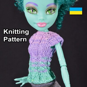 May include: Knitting pattern for a purple and green striped doll sweater. The sweater has a cable knit design and is shown on a doll with green skin and green hair.