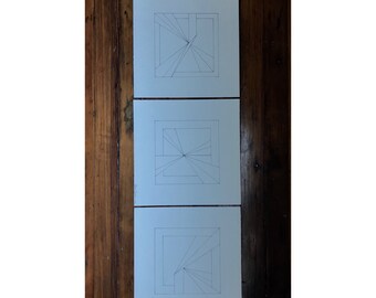 May include: Three white square pieces of paper with black lines drawn on them. The lines are arranged in a geometric pattern that creates a sense of depth and perspective.