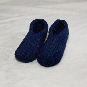 May include: A pair of blue knitted slippers. The slippers are made of a soft, comfortable material and have a simple design.