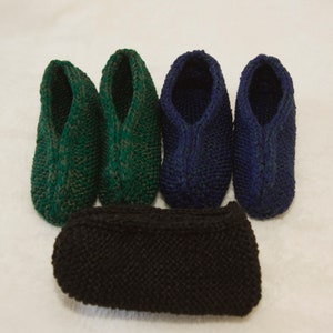 May include: Four pairs of knitted slippers in green and blue colors. One pair of black knitted slippers is in the center of the image.