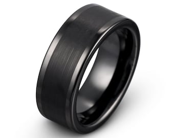 May include: A black tungsten carbide ring with a brushed finish. The ring has a beveled edge and a flat top.