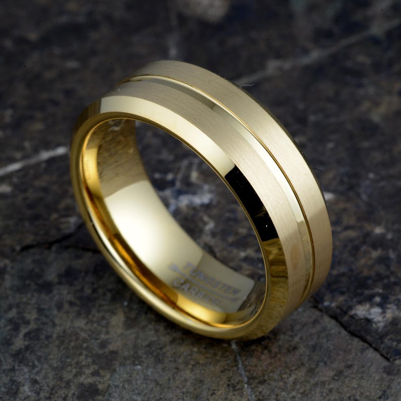 Gold tungsten carbide 8mm ring angled showing contrast between brushed matte exterior and polished groove detail, TUNGSTEN CARBIDE stamped inside