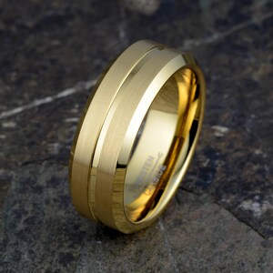 Gold tungsten carbide 8mm mens wedding band angled showing brushed matte finish with polished groove, TUNGSTEN CARBIDE stamped inside, comfort fit ring