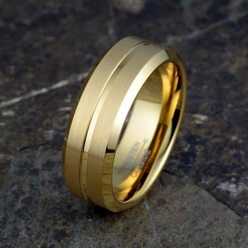Gold tungsten carbide 8mm mens wedding band angled showing brushed matte finish with polished groove, TUNGSTEN CARBIDE stamped inside, comfort fit ring