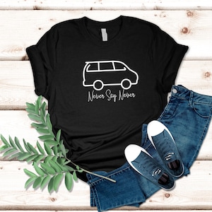 May include: Black t-shirt with a white outline of a van and the text "Never Say Never".