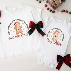 May include: White Christmas-themed shirts and onesie with gingerbread man graphics. The text reads "Next year I'll have to share the cookies" and "Big Brother to be" and "Big Sister to be". Red and green plaid bows are included.