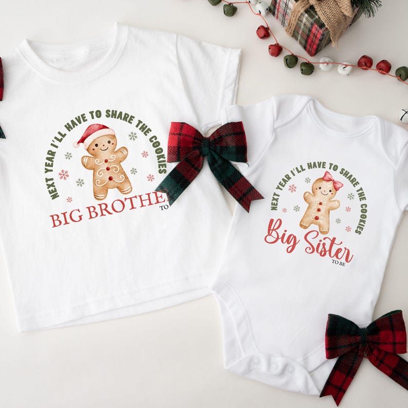 May include: White Christmas-themed shirts and onesie with gingerbread man graphics. The text reads "Next year I'll have to share the cookies" and "Big Brother to be" and "Big Sister to be". Red and green plaid bows are included.