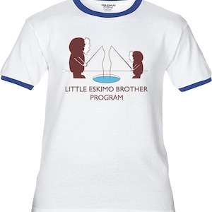 May include: White t-shirt with a blue ringer neck. The shirt features a cartoon image of two people ice fishing with the text "Little Eskimo Brother Program".