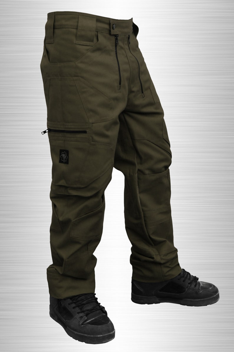 May include: Green cargo pants with multiple pockets and a black zipper. The pants have a relaxed fit and are made of a durable fabric.