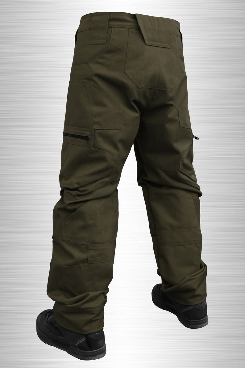 May include: A pair of olive green cargo pants with multiple pockets and a zippered detail on the side. The pants are made of a durable, water-resistant fabric.